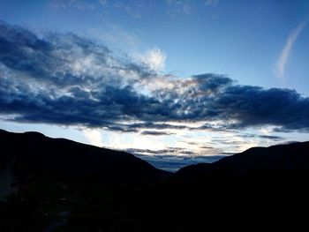 Scenic view of mountains against cloudy sky