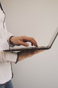 Midsection of man using mobile phone