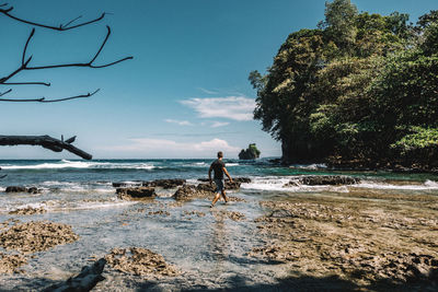 Man on beach against sky