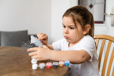 Girl playing with paint at home