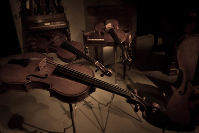 High angle view of violins in darkroom