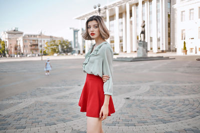 Portrait of young woman standing outdoors