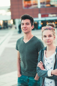 Portrait of young man standing in city