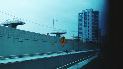 Street amidst buildings in city against sky