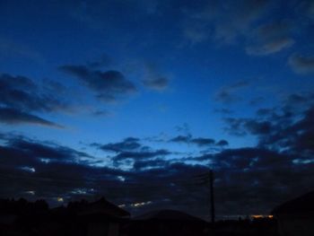 Low angle view of silhouette building against sky