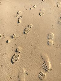 Footprints on the sand beach from a high angle view.