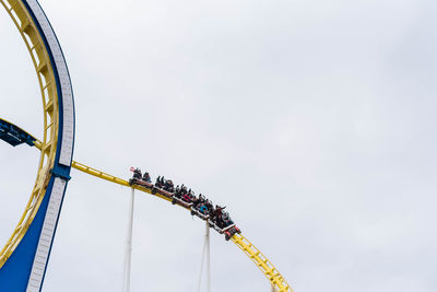 Low angle view of ferris wheel against sky