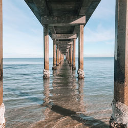 Pier over sea against sky