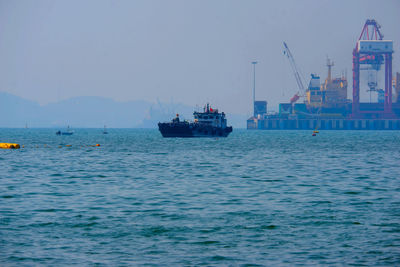 Boat sailing in sea against sky