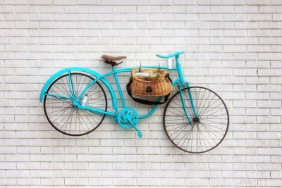 Bicycle in basket on wall