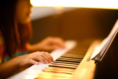 Cropped hand playing piano