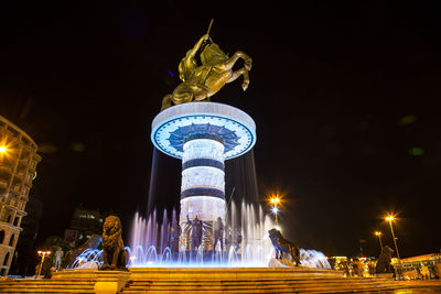 Illuminated fountain at night
