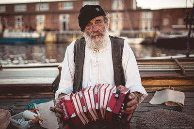 Portrait of senior man holding umbrella