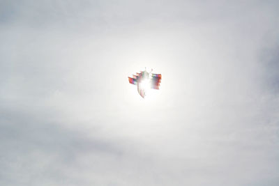 Low angle view of airplane flying against sky