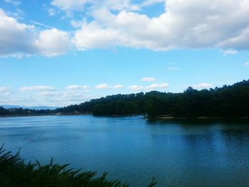 Scenic view of lake against cloudy sky