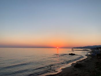 Scenic view of sea against clear sky during sunset