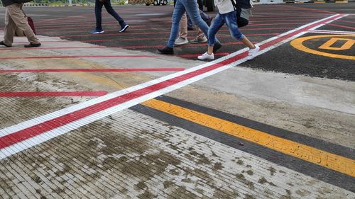 Low section of people walking on road