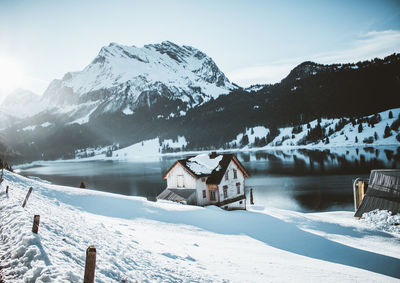 Scenic view of snowcapped mountains by river