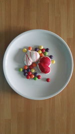High angle view of candies in plate on table