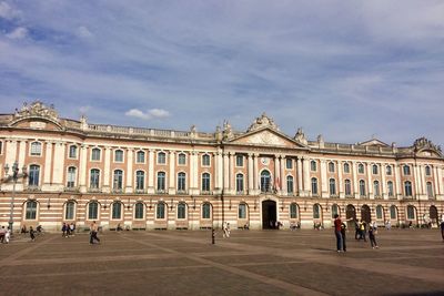 Capitole of toulouse with people against sky