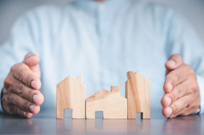 Close-up of hand holding stuffed toy on table