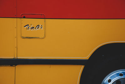 Close-up of yellow sign on car door