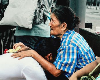 Man and woman sitting on table outdoors