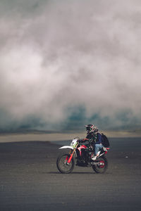 Riding across the sea of sand in mount bromo,  indonesia