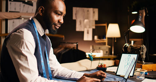 Young man using laptop at table