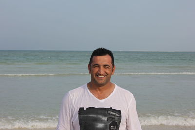 Portrait of smiling young man on beach