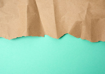 High angle view of paper against blue background