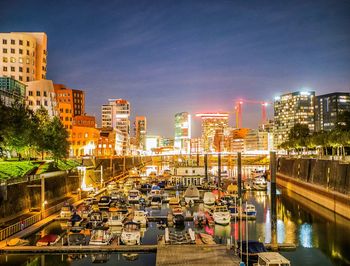 Aerial view of illuminated buildings in city at night