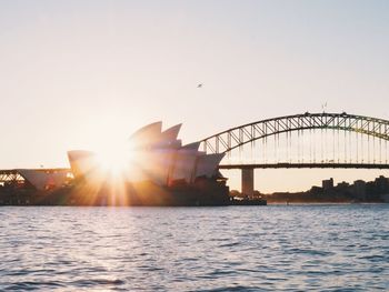 Bridge over river at sunset