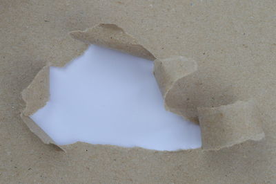 High angle view of broken paper on sand