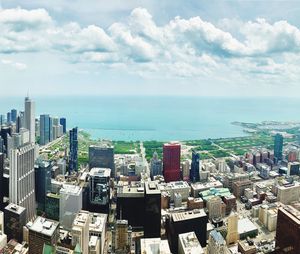 High angle view of buildings by sea against sky