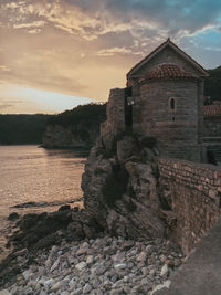 Old ruins of building against sky during sunset