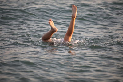 Low section of boy swimming in sea