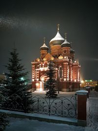 Illuminated building at night during winter