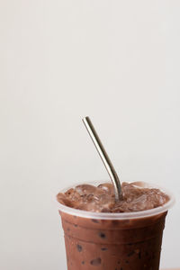 Close-up of coffee cup against white background