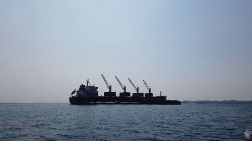 Ship in sea against clear sky