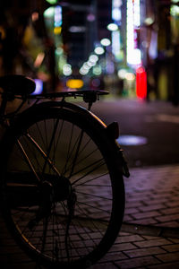 Bicycle parked on street at night