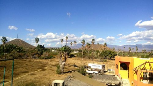 Houses in town against cloudy sky