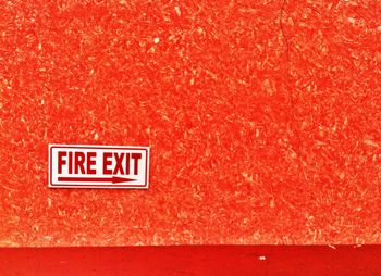 Fire exit sign board on wall