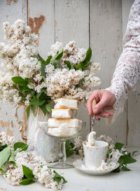 Woman preparing cold coffee dessert, spring still life in retro style, stack of ice cream in bowl