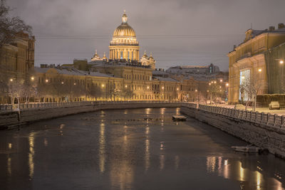 December in saint petersburg, russia. st isaac cathedral and the moyka river after snowfall