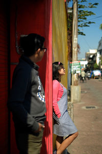 Friends standing on street in city