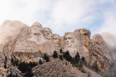 Low angle view of rock formations against sky