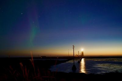 Scenic view of sea against clear sky at night