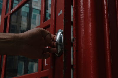 Close-up of hand holding red door