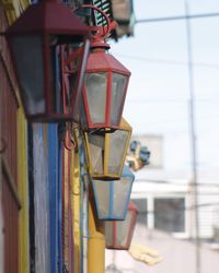 Close-up of electric lamp against building